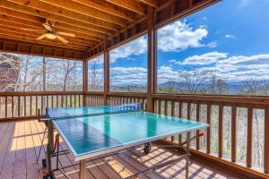a screened in porch with a tennis table on the deck at Fantasy Mountain View in Sevierville