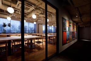 a large room with tables and chairs in it at THE KNOT TOKYO Shinjuku in Tokyo