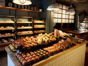 a bakery filled with lots of different types of bread at THE KNOT TOKYO Shinjuku in Tokyo