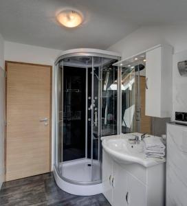 a bathroom with a shower and a sink at Apartments Gasteiger in Lutago