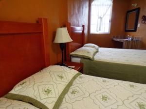 Кровать или кровати в номере Posada "Inkali" Xilitla