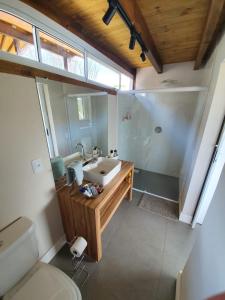 a bathroom with a sink and a shower and a toilet at Descanso do Rosa - cabanas charmosas in Imbituba +31 photos
