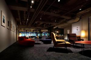 a living room with couches and chairs and tables at THE KNOT TOKYO Shinjuku in Tokyo