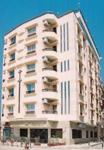 a large white building with balconies on it at Susanna Hotel Luxor in Luxor