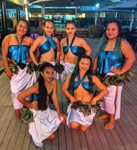 a group of women in blue and white costumes at Pacific Crown Hotel in Honiara