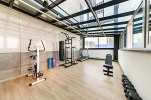 a gym with treadmills and exercise equipment in a building at Gimpo Pentastar Hotel in Gimpo