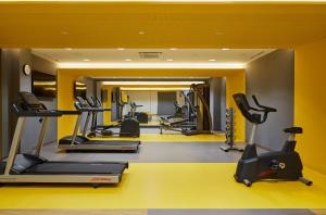 a gym with treadmills and elliptical machines at Hotel Indigo Berlin - East Side Gallery, an IHG Hotel in Berlin