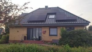 a house with solar panels on the roof at Ferienwohnung Lohf in Handewitt