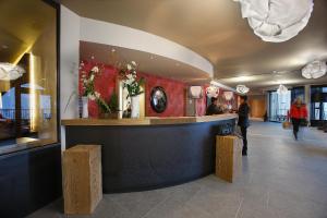 a lobby of a restaurant with a reception counter at Hôtel Koh-I Nor by Les Etincelles in Val Thorens