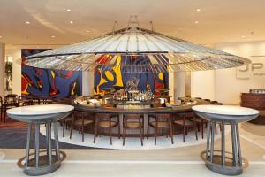 a large chandelier in a restaurant with a table and chairs at Hotel Indigo Atlanta Downtown, an IHG Hotel in Atlanta