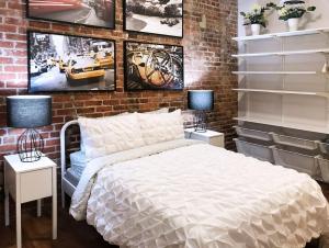 a bedroom with a bed and a brick wall at Downtown Spectrum - Location - Comfort - Style in Atlanta