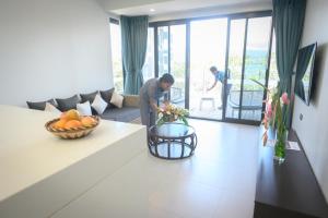 a man standing in a living room with at Loloata Island Resort in Loloata Island