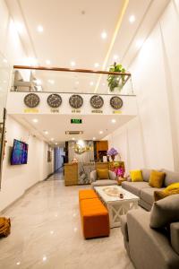 a living room with couches and a table at QUE HUONG HOTEL in Quy Nhon