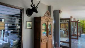 a room with a large wooden cabinet next to a door at Chimera Villas in Seminyak