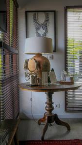 a table with a lamp on top of it at Chimera Villas in Seminyak