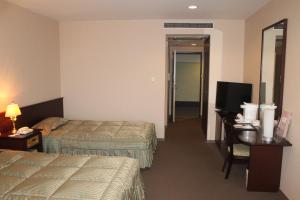Letto o letti in una camera di The Gran Resort Arima