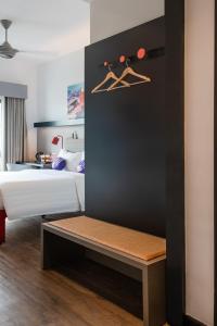 a bedroom with a bed and hangers on the wall at FOX Lite DPulze Cyberjaya by Ascott in Cyberjaya
