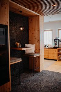a room with a wooden wall with a table and a television at Thalers Mariandl in Schladming +100 photos