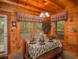 a dining room with a table in a cabin at Forest Fling Cabin in McCookville