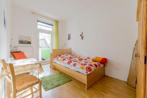 a bedroom with a bed and a table and a window at Private Rooms in Hannover +6 photos