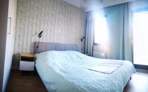 sypialnia z dużym białym łóżkiem i oknem w obiekcie Zielona Krynica Apartament w mieście Krynica Morska