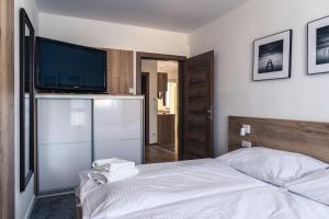 Katil atau katil-katil dalam bilik di TATRYSTAY Tatrahouse Luxury Apartment