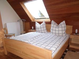 a bedroom with a large bed with a skylight at Ferienwohnung Lehmann 15090 in Leer