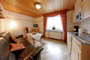 a living room with a couch and a table at Haus Ingrid in Bad Steben