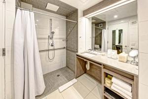 a bathroom with a shower, sink, and tub at Hotel Indigo Brooklyn, an IHG hotel in Brooklyn