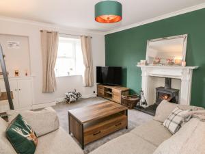 a living room with a couch and a fireplace at Ivy Bank in Thornhill