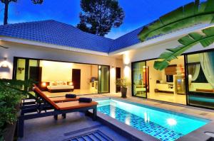 a villa with a swimming pool in front of a house at Chaweng Noi Pool Villa in Chaweng Noi Beach