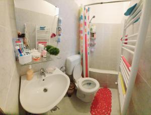 a small bathroom with a sink and a toilet at Happy House in Năvodari +21 photos