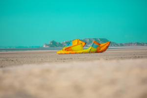 a kite laying on the sand on a beach at PK25 Dakhla in Dakhla
