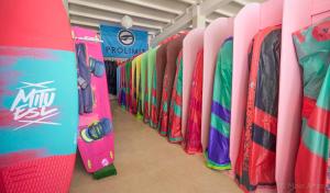 a row of surfboards are lined up in a rack at PK25 Dakhla in Dakhla