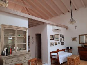 a room with a bedroom with a table and chairs at En Patmo Holiday Home in Patmos