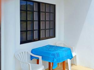 a table and two white chairs and a window at Aquarius Terraces Boutique Resort in Boracay
