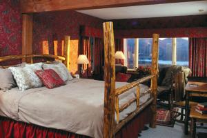 a bedroom with a bed with a wooden frame at The Mountain Top Inn & Resort in Chittenden