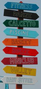 a sign with many different colored signs on it at Residence Margherita in Cattolica