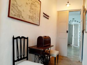 a room with a table and a chair and a map on the wall at En Patmo Holiday Home in Patmos