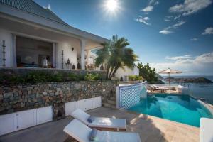 a villa with a swimming pool and a house at Dream Villa Corossol 816 in Gustavia