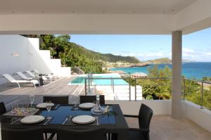 a dining room with a view of the ocean at Dream Villa Flamands 606 in Anse des Cayes