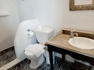 a bathroom with a white toilet and a sink at En Patmo Holiday Home in Patmos