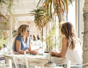 two women sitting at a table in a restaurant at PK25 Dakhla in Dakhla