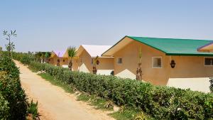 a dirt road in front of a row of houses at PK25 Dakhla in Dakhla