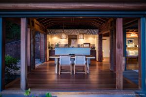 a dining room and kitchen with a table and chairs at Dream Villa Pointe Milou 857 in Saint Barthelemy