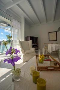 a living room with a table with a vase of flowers at Dream Villa Gustavia 868 in Gustavia