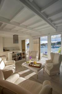 a living room with couches and a table and a kitchen at Dream Villa Gustavia 868 in Gustavia