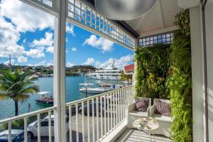 a balcony with a view of the water and a cruise ship at Dream Villa Gustavia 868 in Gustavia