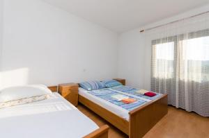 Postel nebo postele na pokoji v ubytování Apartments Boza