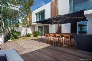 a patio with a table and chairs and an umbrella at Dream Villa St Jean 891 in Saint Barthelemy